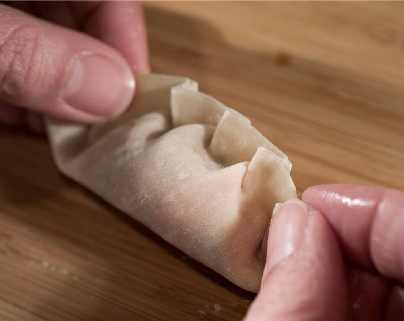 step 7 Repeat this all wrappers have been filled. Keep all dumplings under a damp tea towel until ready to steam.