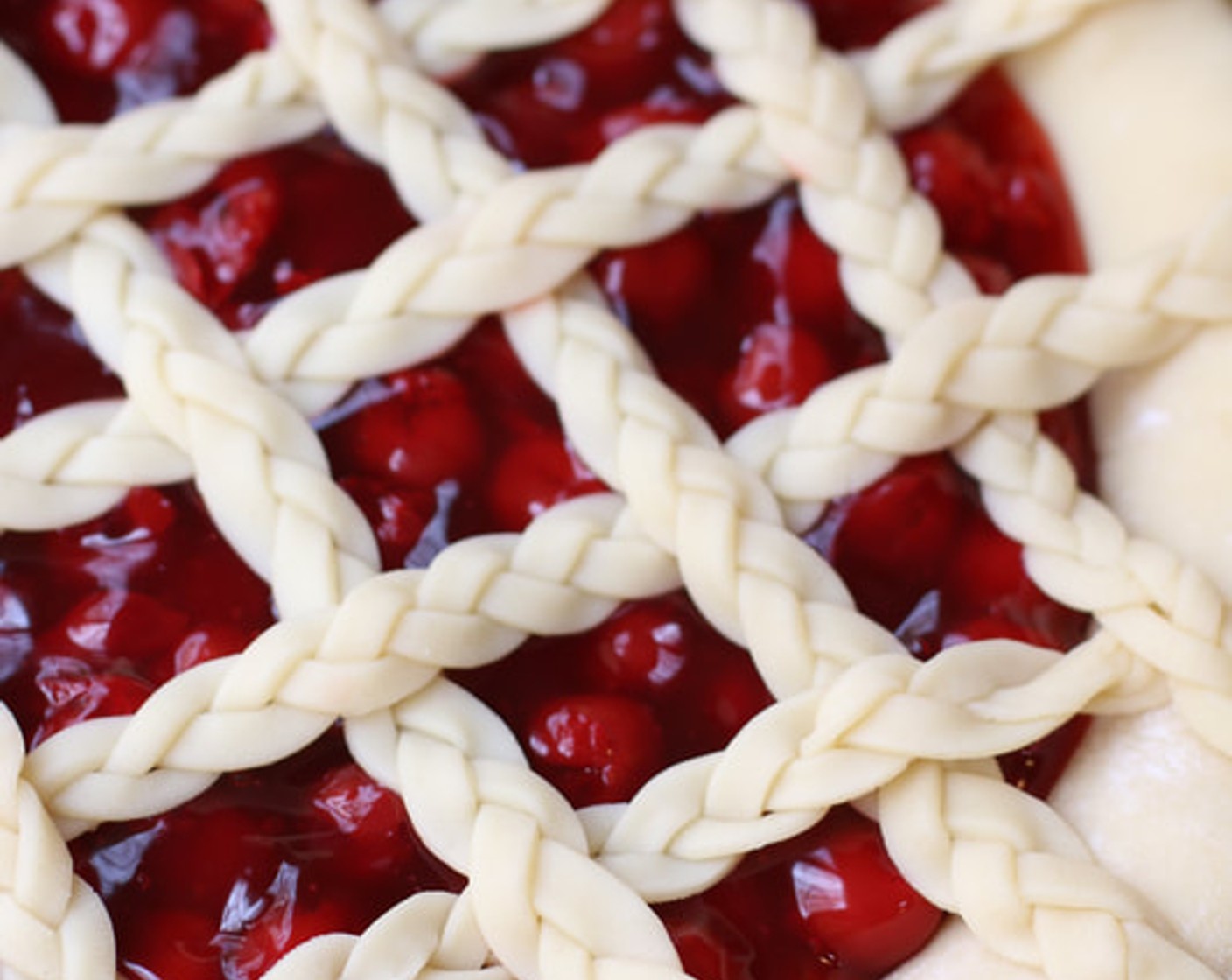 step 10 Remove the pie from the refrigerator and carefully thread the pie dough strips over and under one another, pulling back strips as necessary to weave.  Press the edges of the strips into the bottom pie crust edges to seal. Use a small knife to trim off excess dough.