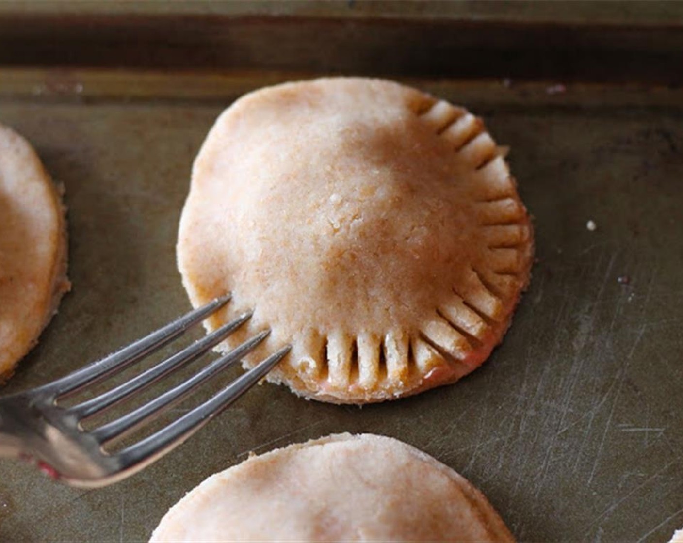 step 11 Top with another pastry circle. Press both sides together with a fork.