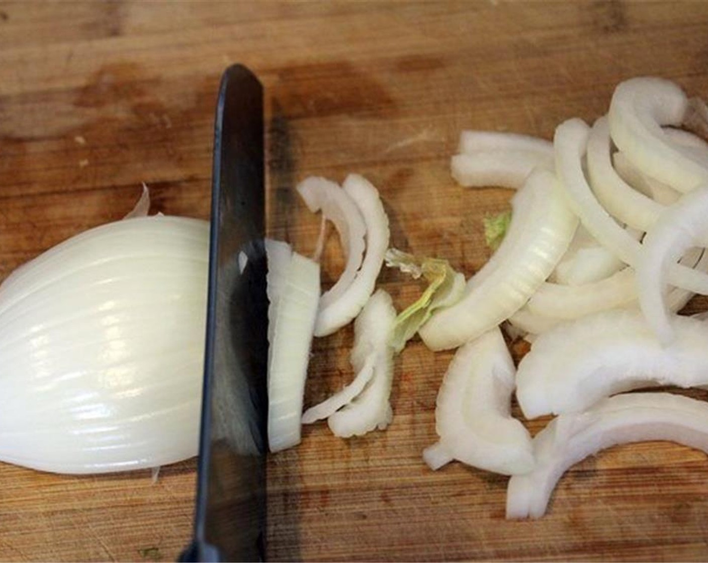 step 8 While the chicken is cooking, slice the Onion (1/2).