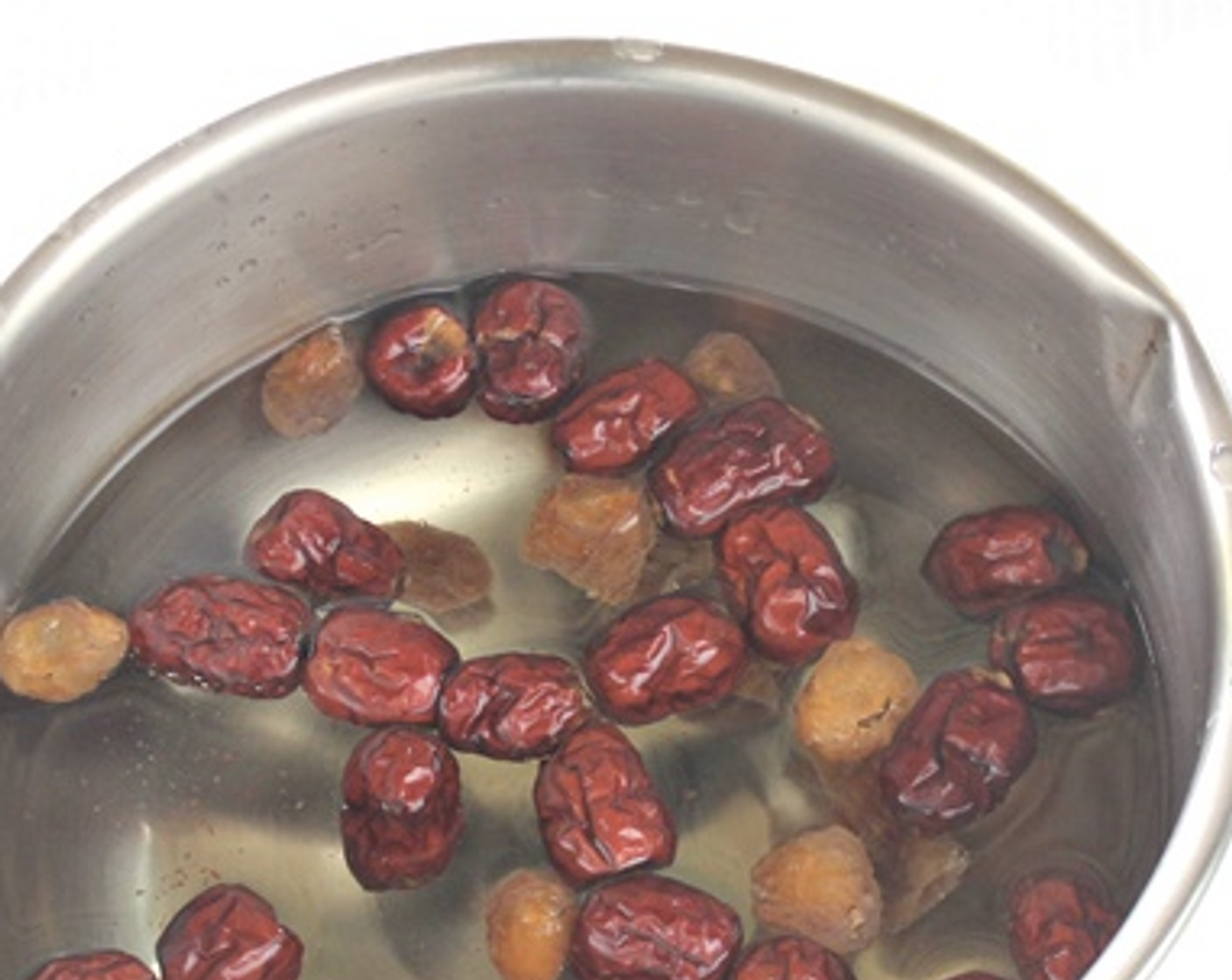 step 4 Mooncakes skin - In a pot, combine Water (3 cups), Dried Red Dates (1/3 cup), Dried Longan (2 Tbsp) and Rock Sugar (4 Tbsp) together to boil and simmer for 20 minutes under low heat with the lid on.