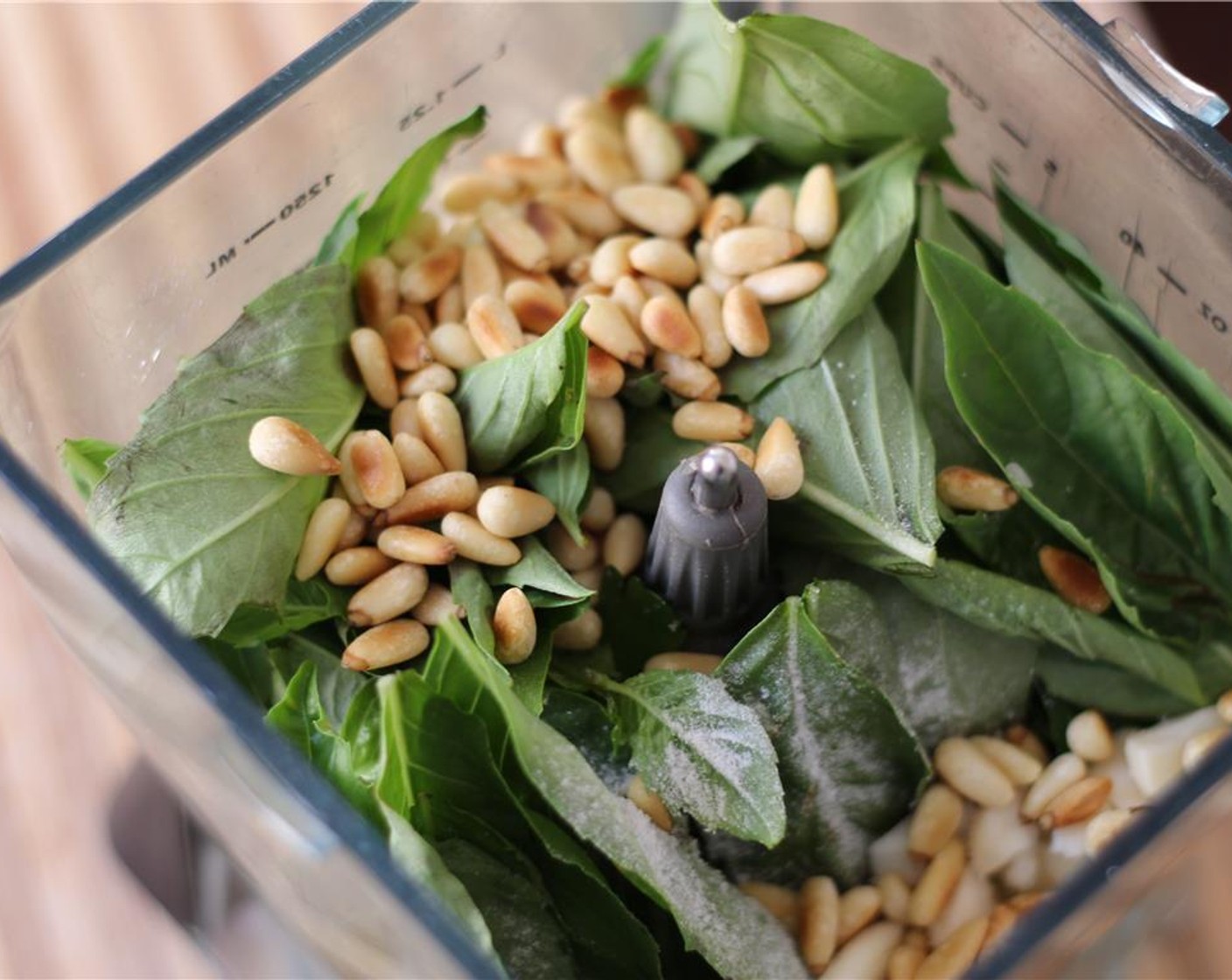 step 2 Combine the Fresh Basil Leaves (2 cups), Salt (to taste), Garlic (2 cloves), pine nuts, Ground Black Pepper (to taste), and about half the Extra-Virgin Olive Oil (1/2 cup) in a small food processor or blender.