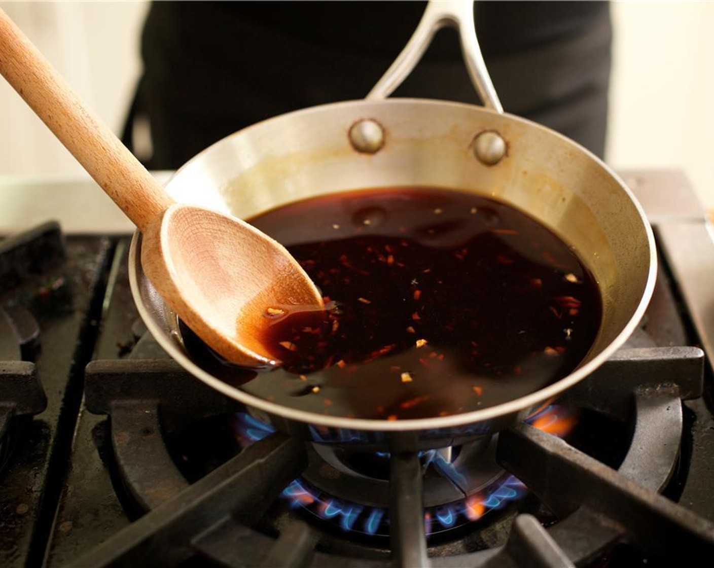 step 5 In the same medium saute pan as the ginger and garlic add the Tamari Soy Sauce (1/2 cup), 1/2 cup of water and the Brown Sugar (4 Tbsp) and bring to a simmer over medium heat, stirring occasionally until sugar dissolves. Bring the sauce to a quick boil, stir and then remove from heat.