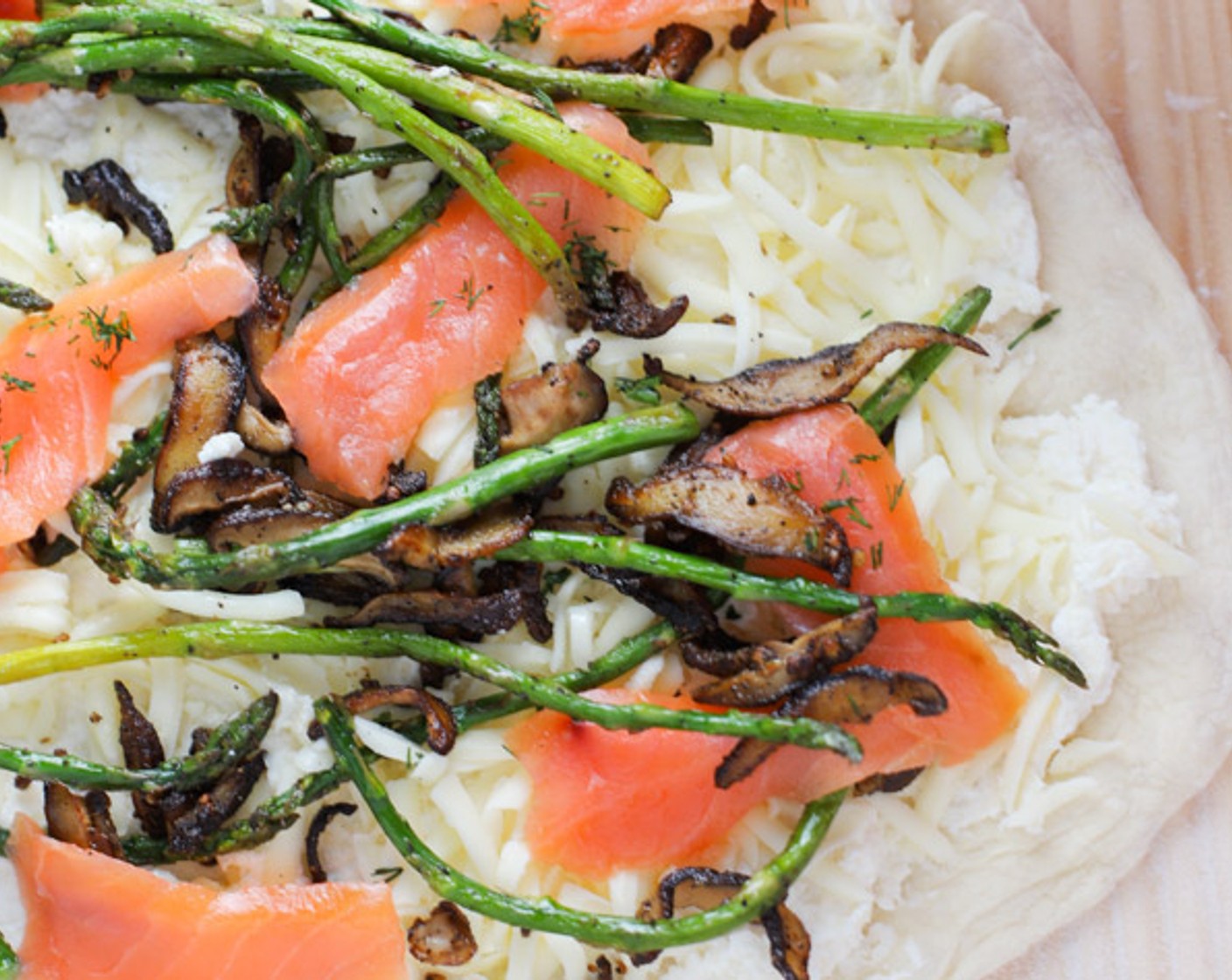 step 5 Spread the ricotta mixture on the pie. Top with Provolone Cheese (1/2 cup) and Mozzarella Cheese (1/2 cup). Scatter the sauteed asparagus and mushrooms on top. Lay Smoked Salmon (2 oz) over the pie. Sprinkle with Dried Dill Weed (1 tsp).