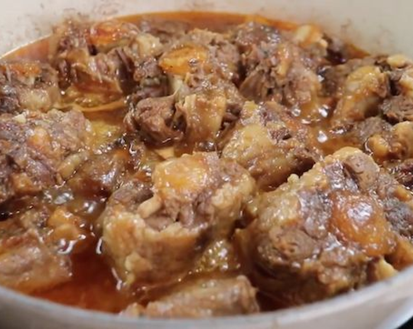 step 3 When you feel that the oxtail is beginning to feel tender add Onion (1/2), Green Bell Pepper (1), Red Bell Pepper (1), Pitted Green Olives (1/4 cup), and Tomato Sauce (2 Tbsp). Stir well and continue to simmer for 20-30 minutes until you feel it is tender enough for your liking, especially the bigger pieces.