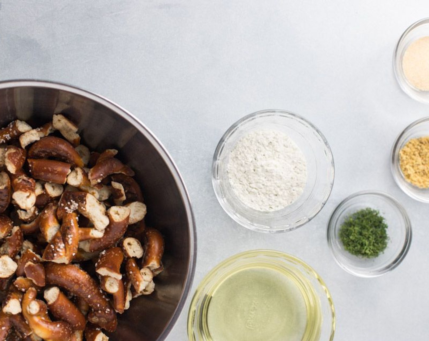 step 2 Mix Sourdough Pretzel Pieces (2 2/3 cups), Ranch Seasoning Powder Mix (1 pckg), McCormick® Garlic Powder (1/2 Tbsp), Lemon Pepper (1/2 Tbsp), Dried Dill Weed (1/2 Tbsp) and Canola Oil (1 cup) together in a large bowl.