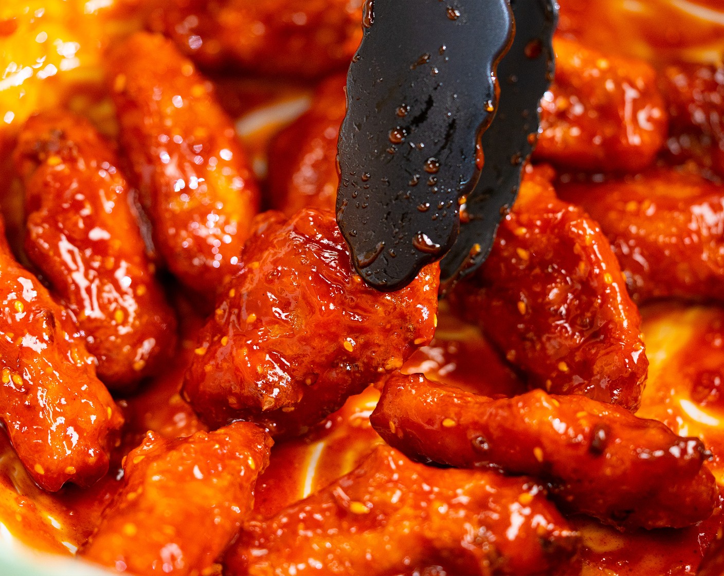 step 8 Add wings to a large bowl and drizzle with the sauce. Toss gently until fully coated.
