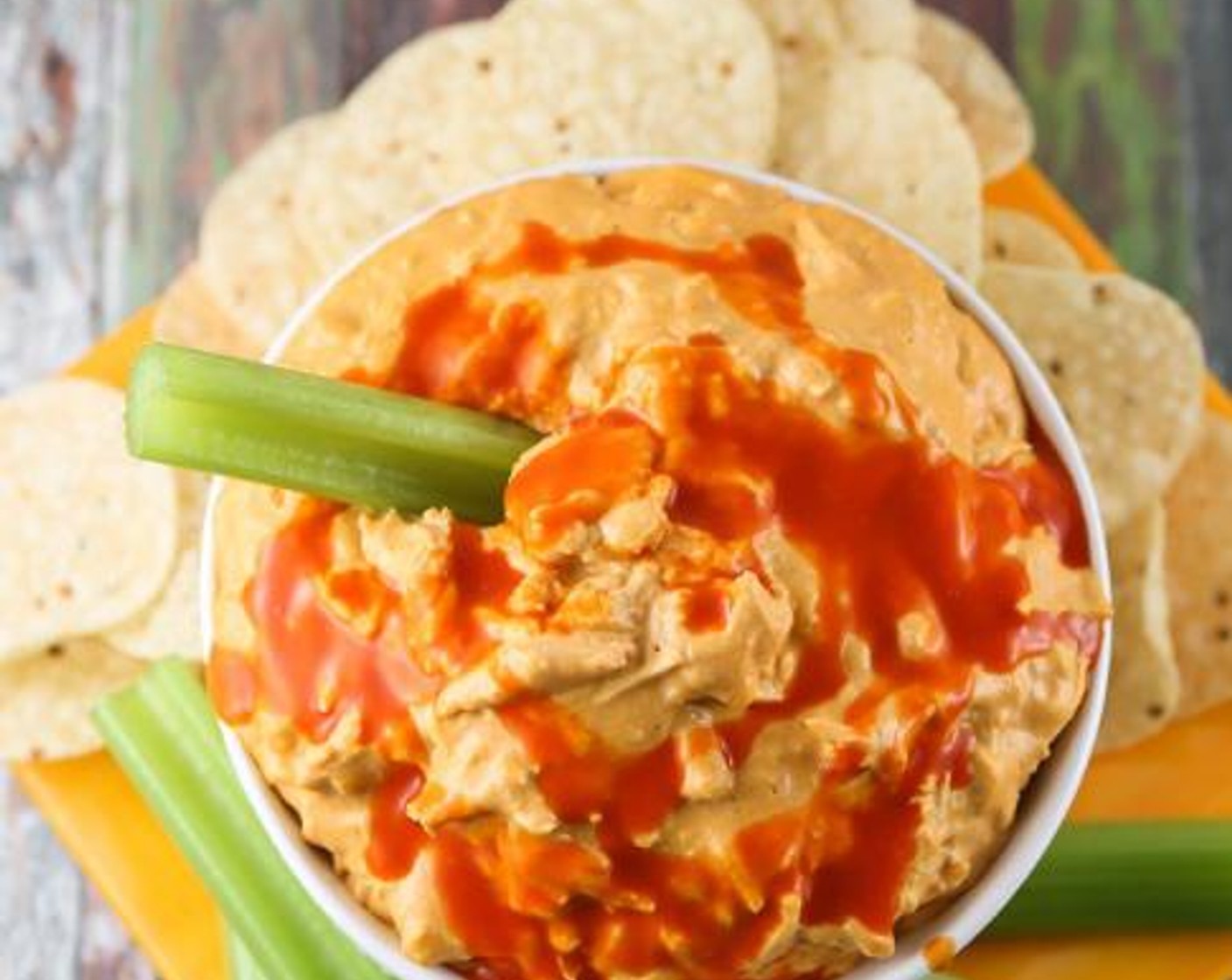 step 1 Combine the Chicken (2 cups), Cream Cheese (1 pckg), Shredded Mozzarella Cheese (1 cup), Ranch Dressing (3/4 cup), Buffalo Sauce (1 cup), and Blue Cheese (1 cup) in a crockpot. Cook on High heat for 2 hours, stirring occasionally, and serve with crackers and veggies.
