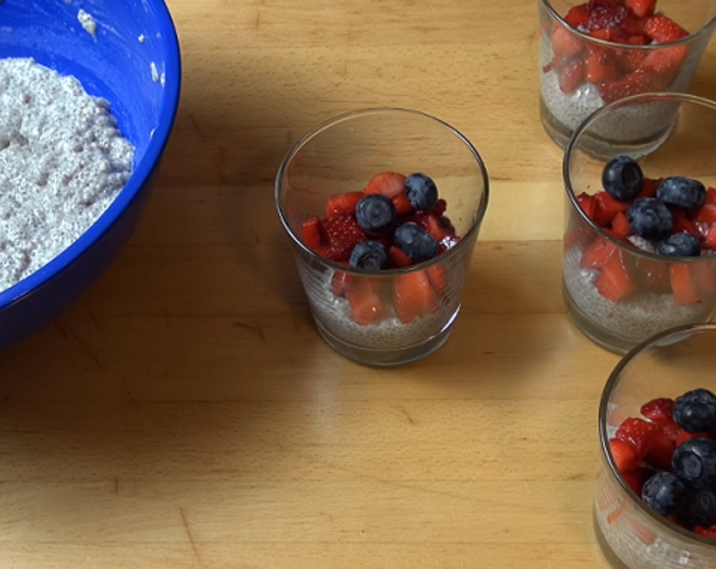 step 2 After letting the pudding sit, stir the mixture. Spoon a small amount of the pudding into each serving glass, followed by a bit of the Fresh Strawberries (3 1/3 cups) and Fresh Blueberry (3/4 cup). Repeat. Cover the glasses and let chill in the fridge for 2 hours or overnight.