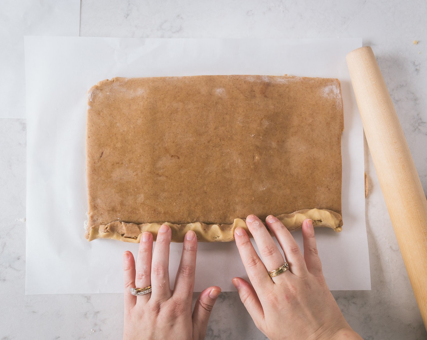 step 9 Place the cinnamon dough on top of the plain dough and roll out further into a 10x14 inch rectangle.