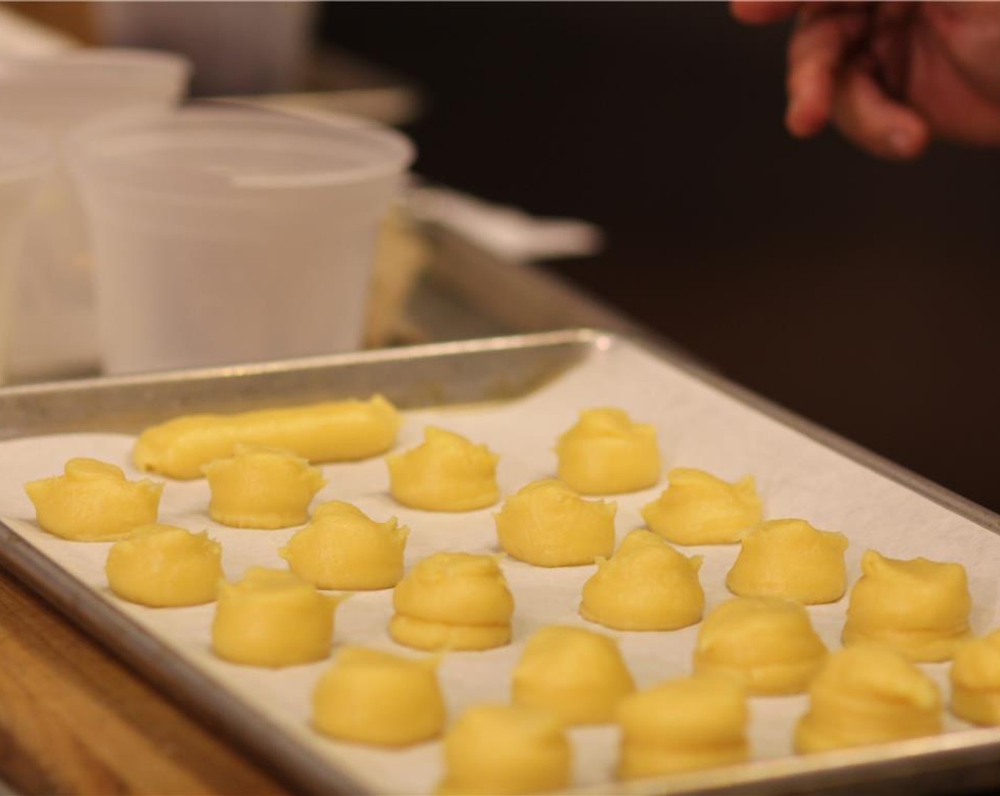 step 6 Take two spoons dipped in cold water and shape the profiteroles into rough spheres.