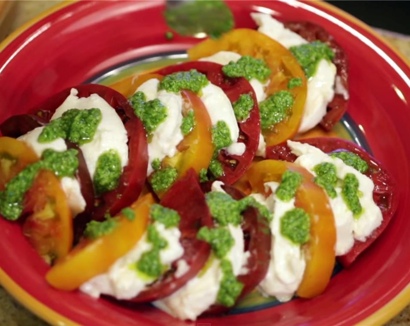 step 7 In a small bowl, combine 2 teaspoons of pesto with 3 tablespoons of your best quality olive oil until blended. Drizzle over tomato and mozzarella slices.