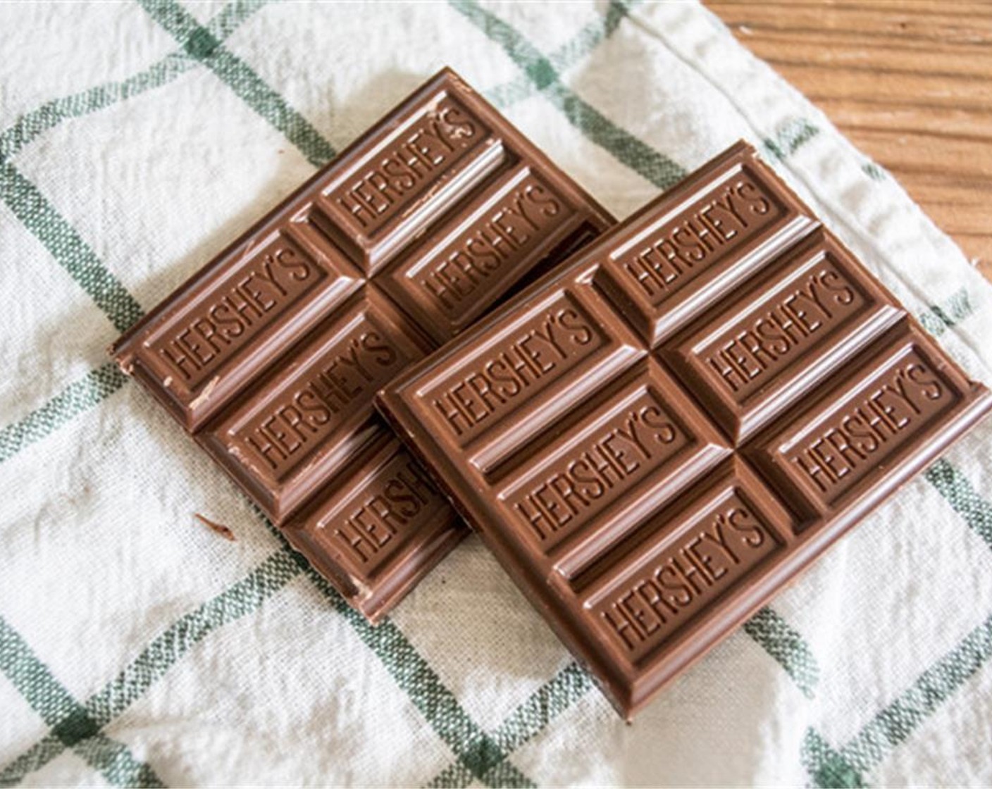 step 5 Chop up the Milk Chocolate (1 bar). Line and 8x8-inch pan with parchment paper, spray the parchment paper with Coconut Oil Cooking Spray (as needed) then pour the batter into a lined pan. Smooth the top with a spatula and sprinkle with chopped Hershey's.