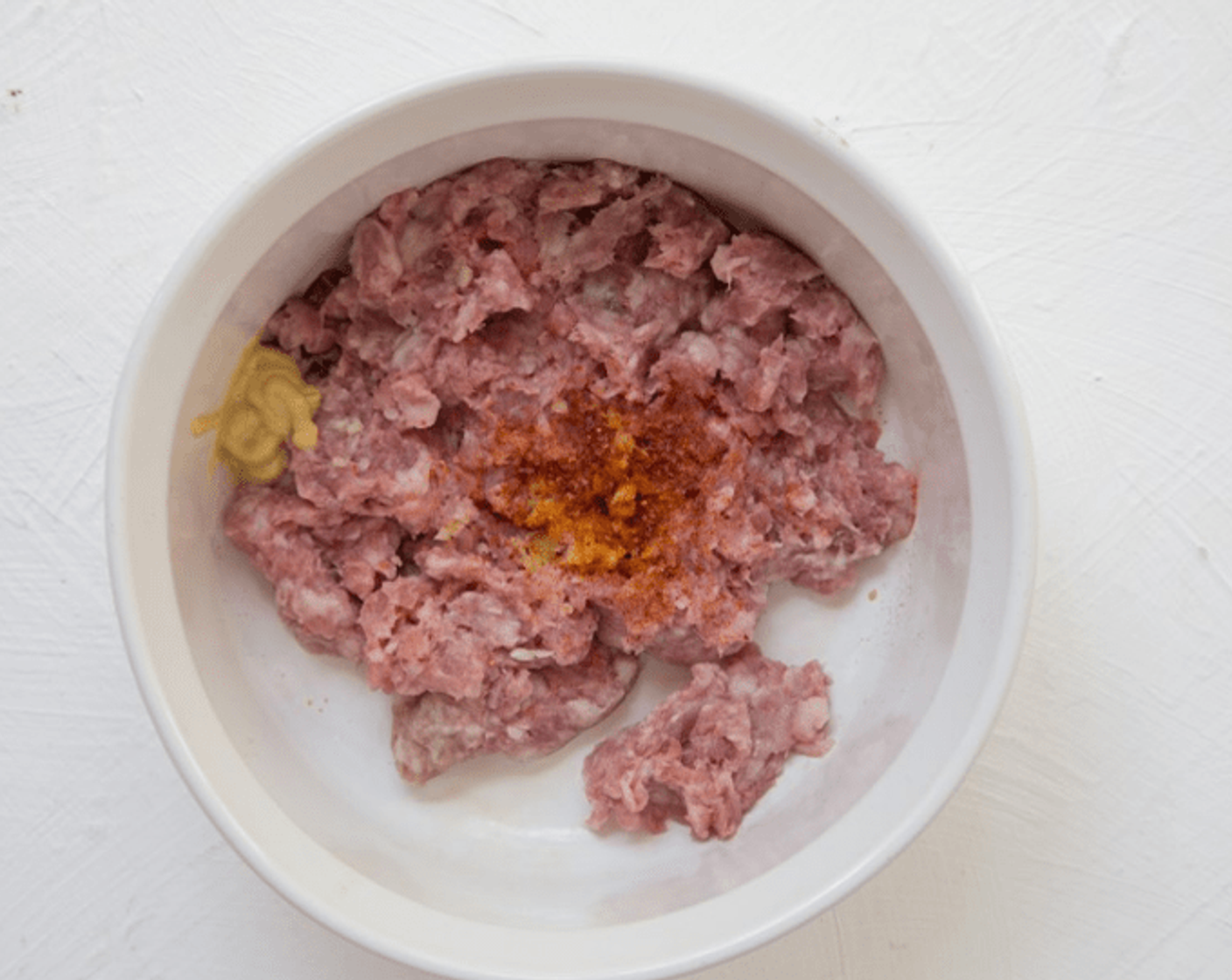 step 6 In a mixing bowl, combine Ground Pork (to taste), half of chopped garlic, Spicy Brown Mustard (to taste) and remaining Salt (1/2 tsp). Mix well, and divide into 4 equal portions.