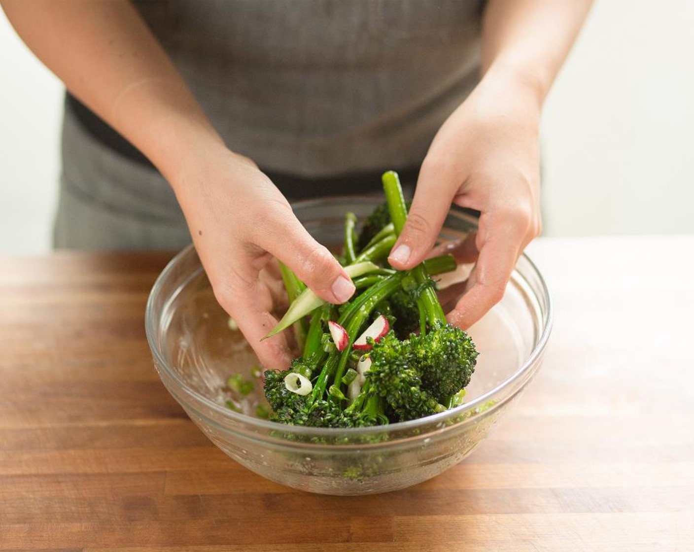 step 11 In a large bowl, place the radishes, green onions and the broccolini. Whisk the dressing again and add to the veggies; toss and get ready to plate.