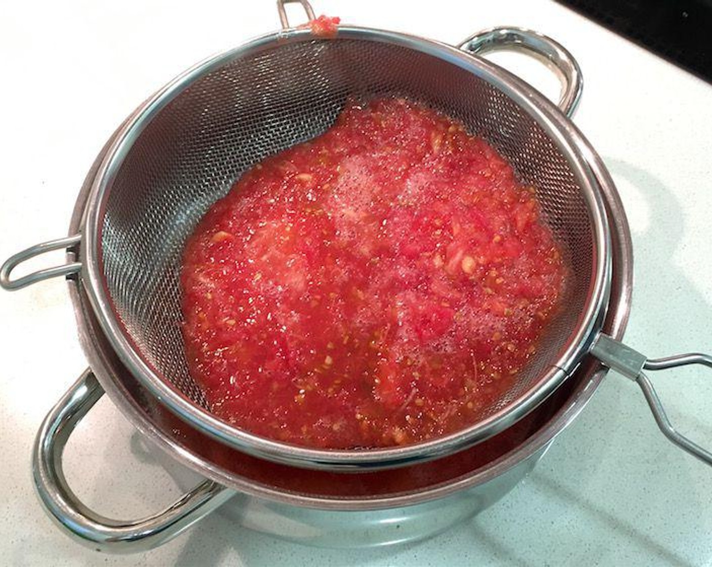 step 3 If desired, transfer grated tomato pulp into a sieve to drain excess liquid, do not press. Remove any large bits of tomato core.