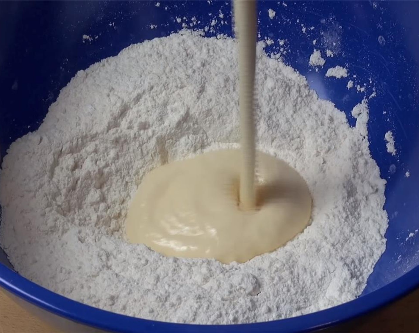 step 3 Make a well at the middle of the flour and add the yogurt mixture. Stir until just combined.