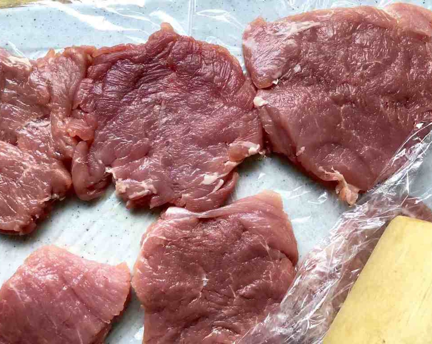 step 2 Place pieces between sheets of plastic wrap. Using the flat side of a meat mallet, pound each piece to an even thickness, about 1/4-inch to 1/2-inch.