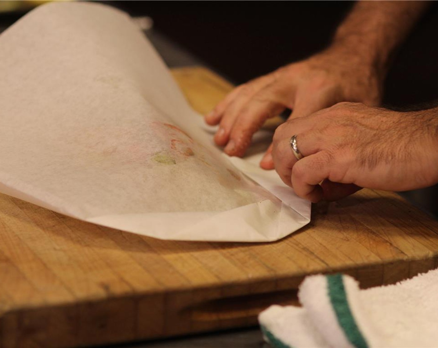 step 12 Fold the parchment paper around the edges tightly in 1/4-inch folds to create a half moon shape. Make sure you press as you crimp and fold to seal the packets well, otherwise the steam will escape.