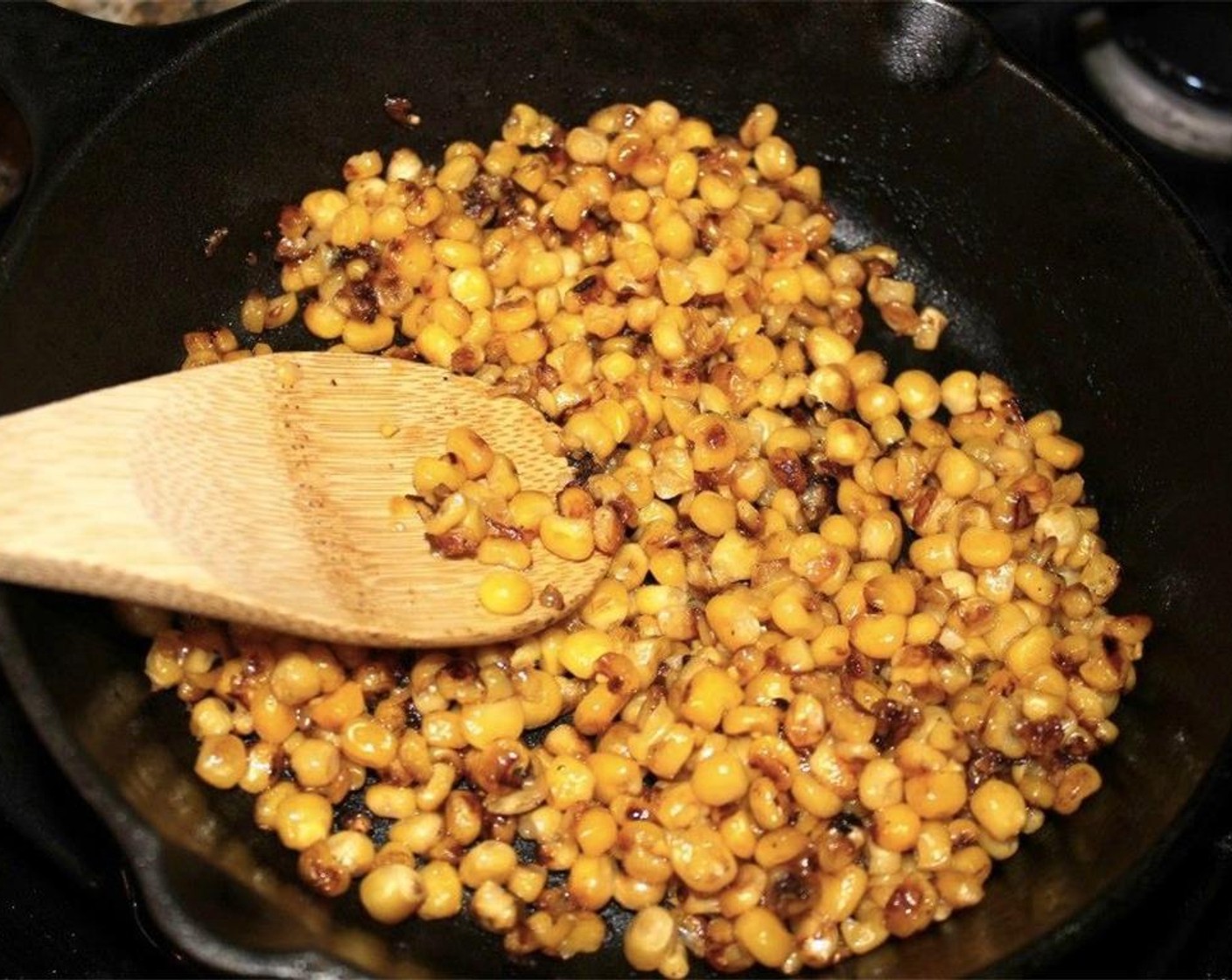 step 2 Heat Canola Oil (4 Tbsp) in a cast-iron skillet. When it is very hot, add the drained Whole Kernel Corn (2 cans). It will start to pop.
