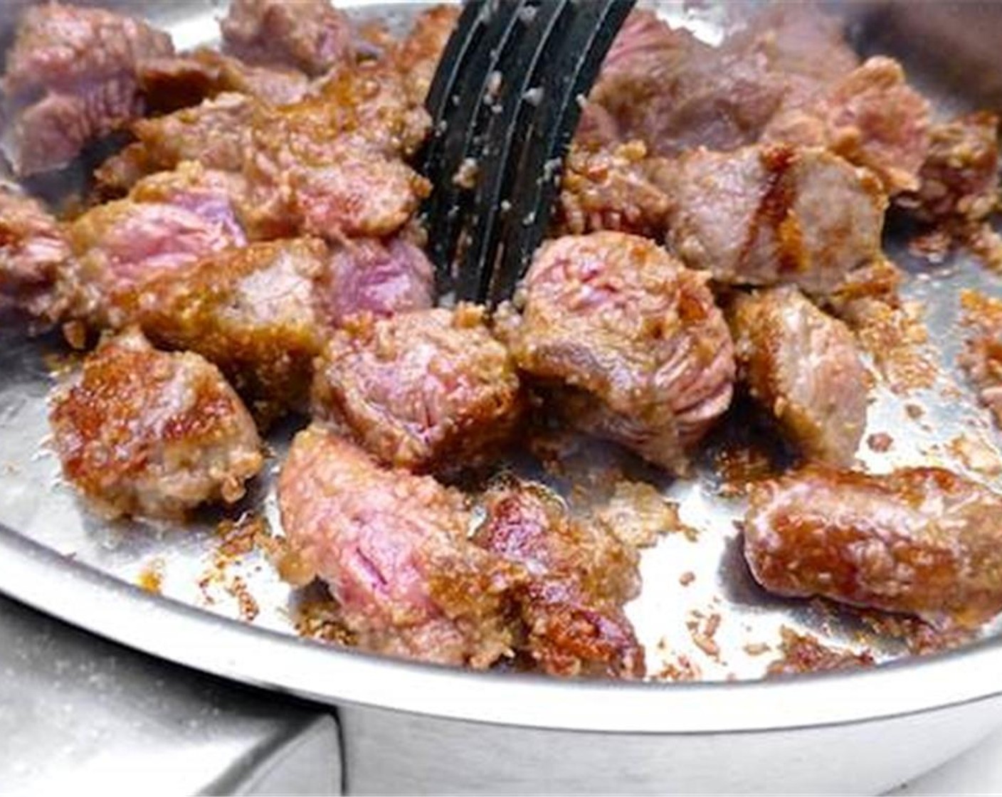 step 3 Quickly sear the beef on all sides for 3 to 4 minutes. Stir continuously to prevent the beef from burning.