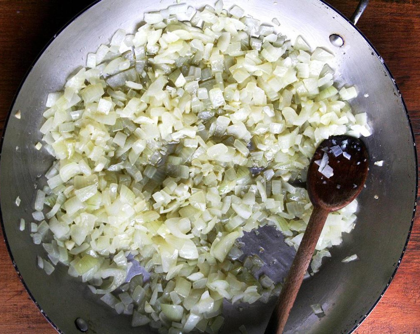 step 2 Heat the Olive Oil (1/4 cup) in a large oven proof sauté pan over medium heat, add the Spanish Onion (1) and Garlic (3 cloves) and cook for about 5 minutes until translucent.