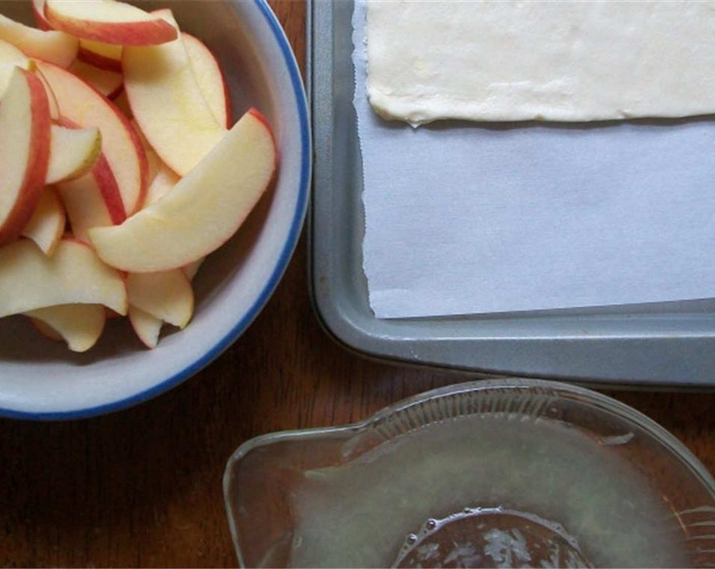 step 1 Toss Red Apples (2) in juice from Lemon (1) and mix with half of the Brown Sugar (1/2 cup), Salt (1 pinch) and Ground Cinnamon (1 tsp). Let sit for 15 minutes before placing on puff pastry (1 pckg).