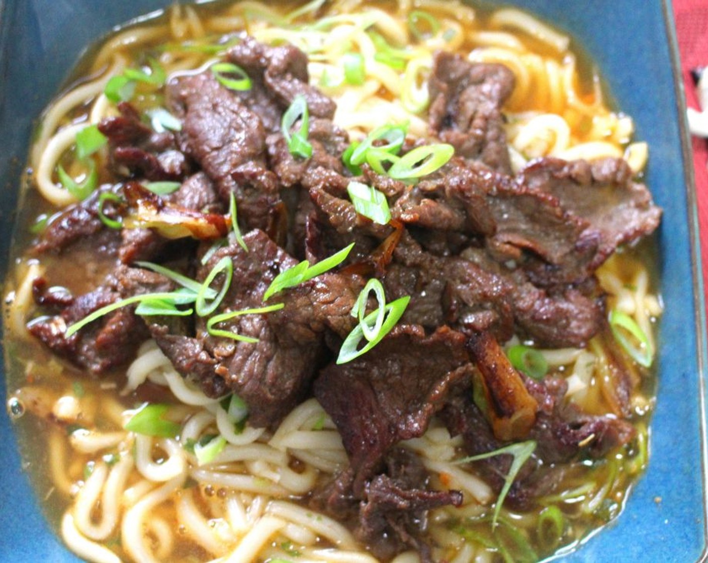 step 8 Add the udon with the broth to a deep serving dish, top with the beef, sprinkle with Scallions (to taste).