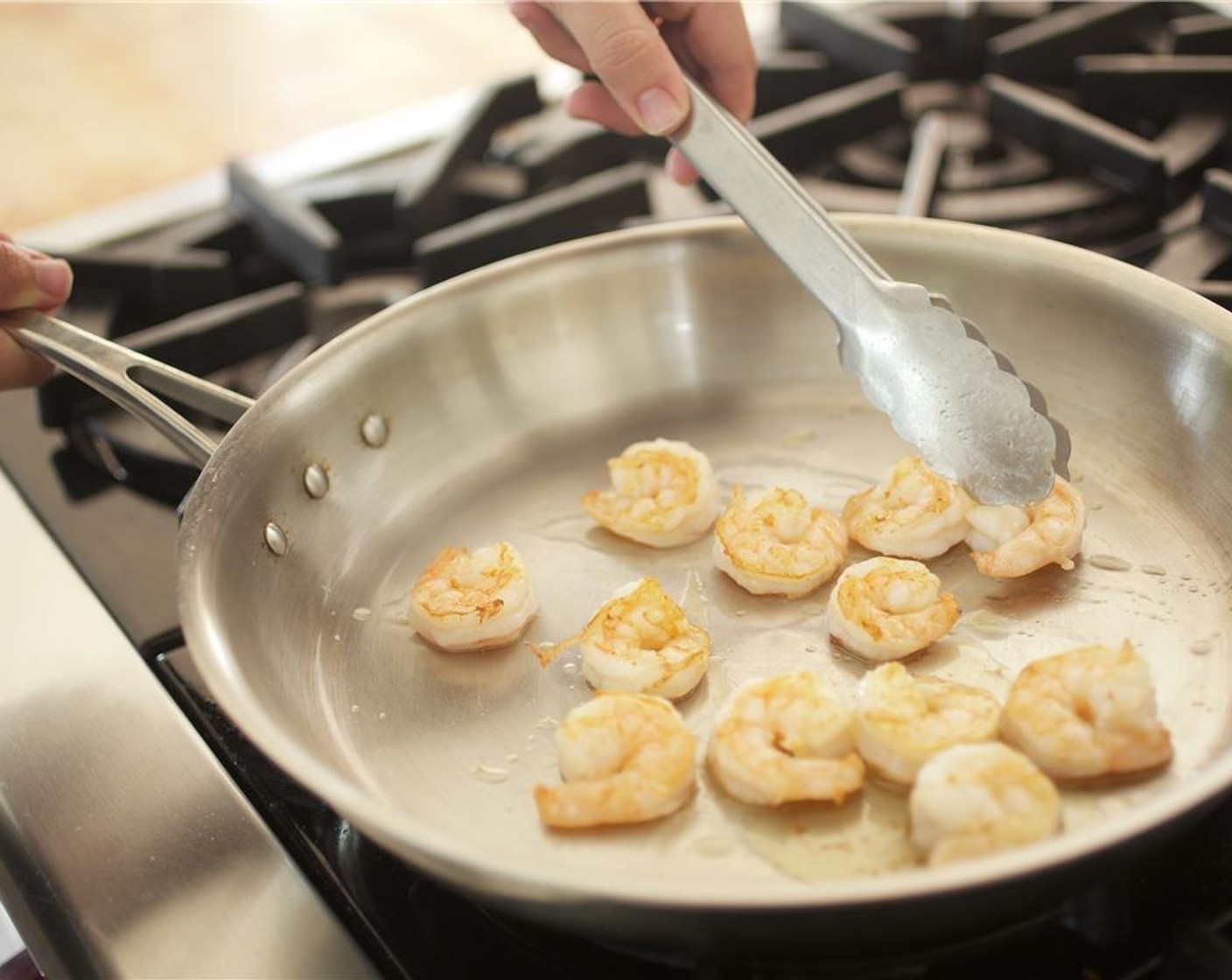 step 3 Pat dry Shrimp (12) with paper towels, and set aside. Heat a large saute pan over medium high heat. Add one teaspoon of Sesame Oil (1 tsp) to the pan and swirl pan evenly to coat the bottom. Once oil is hot, using tongs, carefully add the shrimp to the pan in a single layer.