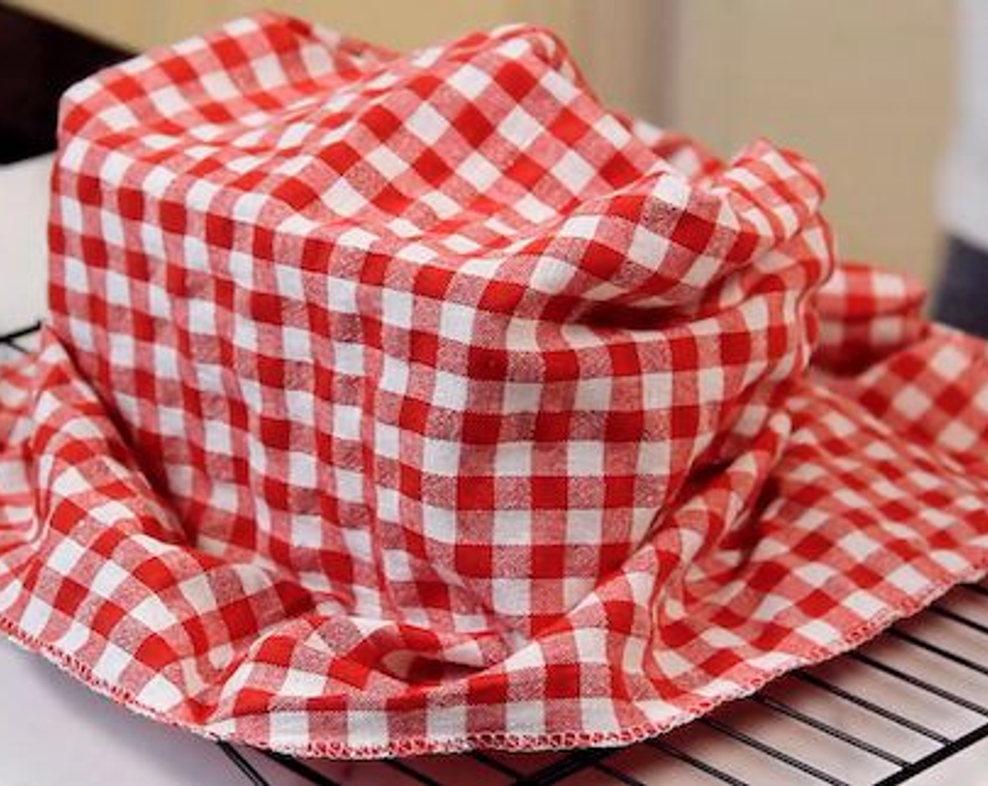 step 9 Once baked, carefully unmould the bread immediately and let it cool over a wire rack with a piece of cloth covering lightly.