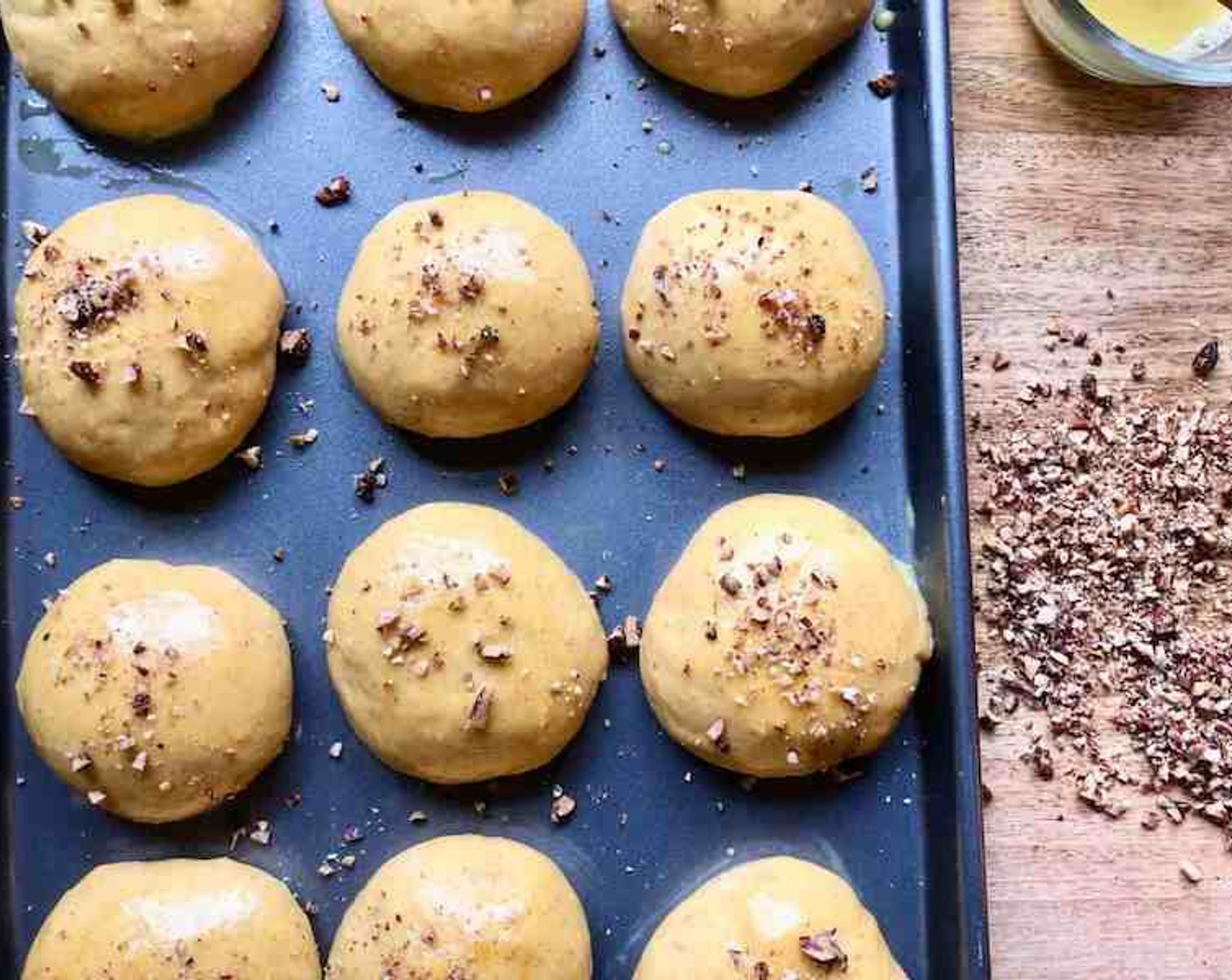 step 10 Whisk together the egg yolk and 1 Tbsp of water. Brush the rolls with the yolk mixture. Sprinkle lightly with Chopped Pecans (1/2 cup).