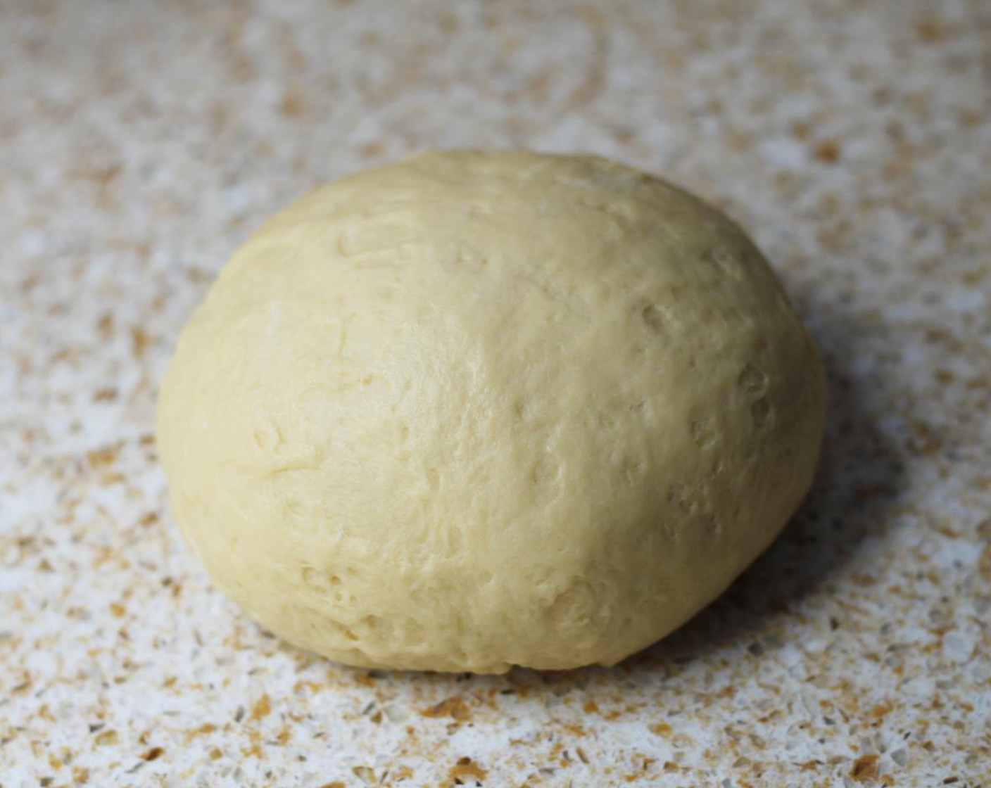 step 6 Turn the dough out on to a lightly floured surface and knead by hand for about 5 minutes until smooth and elastic.