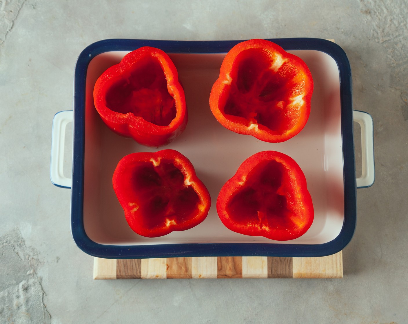 step 2 Cut the tops off the Bell Peppers (4) and remove the seeds. Place the peppers cut side up in a baking pan filled with Water (1/2 cup). Bake at 350 degrees F (180 degrees C) for 10 minutes to soften.