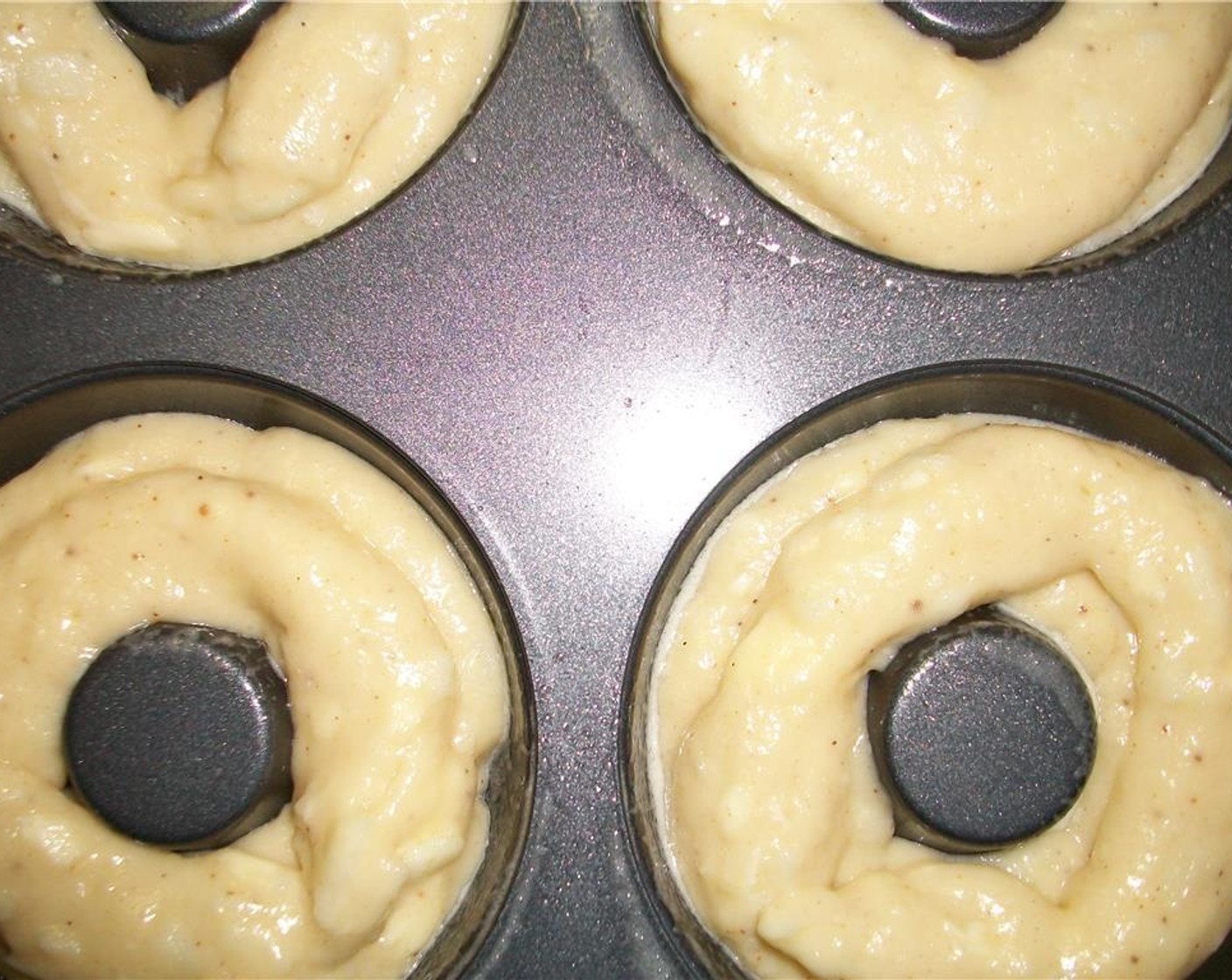 step 5 Place the batter into a ziplock bag and cut off the corner tip of the bag. Using it like a pastry bag, fill the donut tin up about half way.