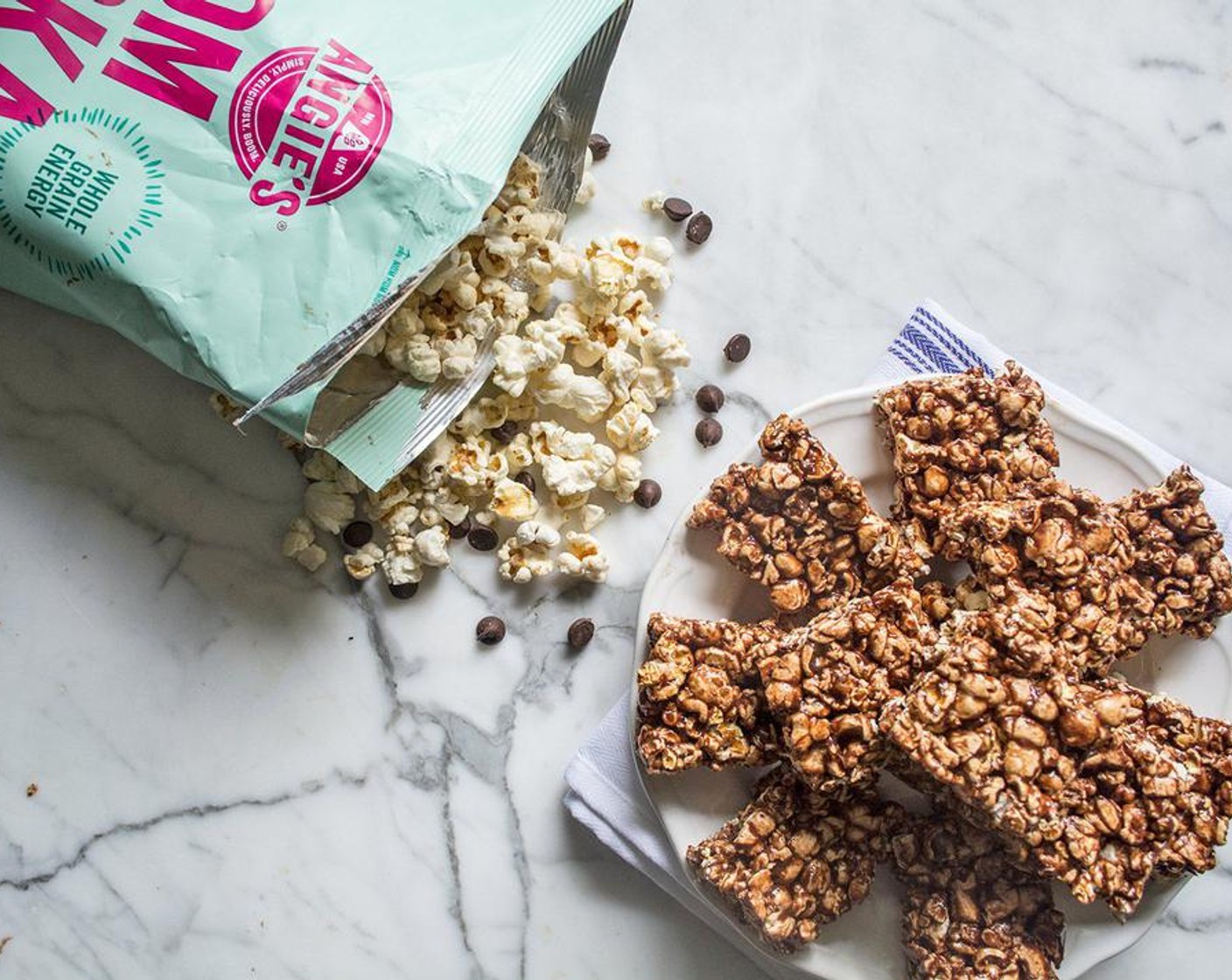 step 6 Spoon chocolate covered popcorn into prepared 9x13 baking dish. Use spatula to press popcorn firmly into even layer, then put in refrigerator 25-30 minutes or until bars have harden enough to cut through with sharp knife.