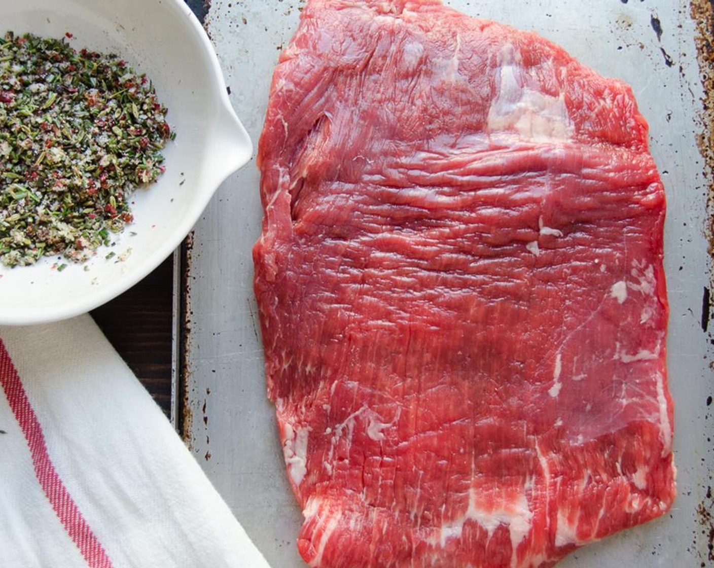 step 4 Place the Flank Steak (1.5 lb) on a platter or rimmed baking sheet. Rub half of the Olive Oil (1/2 Tbsp) over one side of the steak.