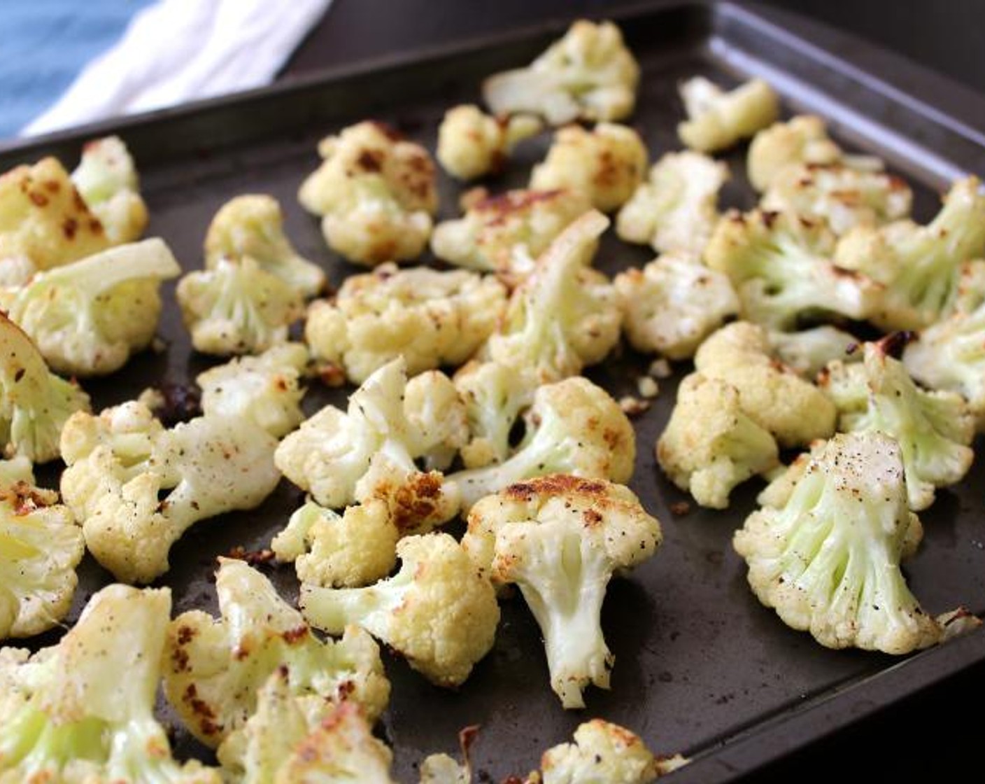 step 2 Place the Cauliflower (1) in one layer on a sheet pan. Toss with Extra-Virgin Olive Oil (3 Tbsp), Kosher Salt (3/4 tsp) and Ground Black Pepper (1/2 tsp)
