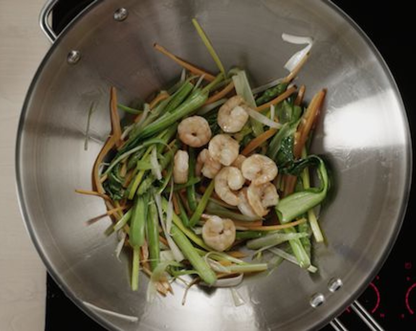 step 9 Next, place the shrimps back in the wok and stir-fry for a maximum of 30 seconds to get the outer layers golden brown and crispy. Season with Salt (to taste).