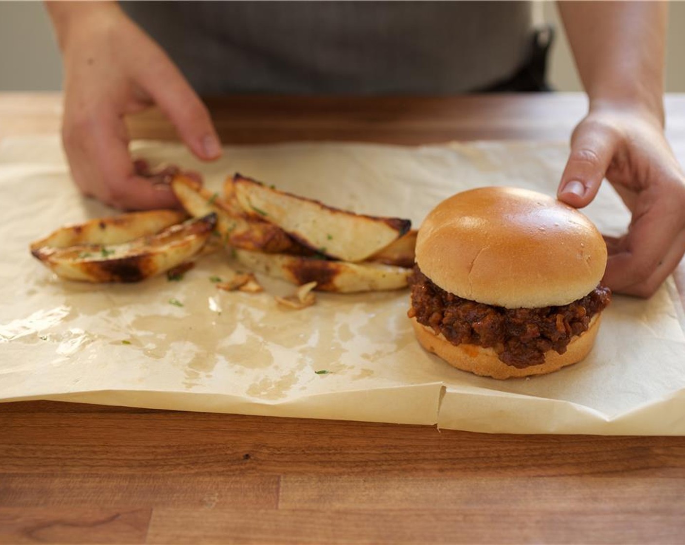 step 10 Divide the beef mixture evenly between 2 buns. Plate the sandwich with potato fries. Serve with ketchup. Enjoy!