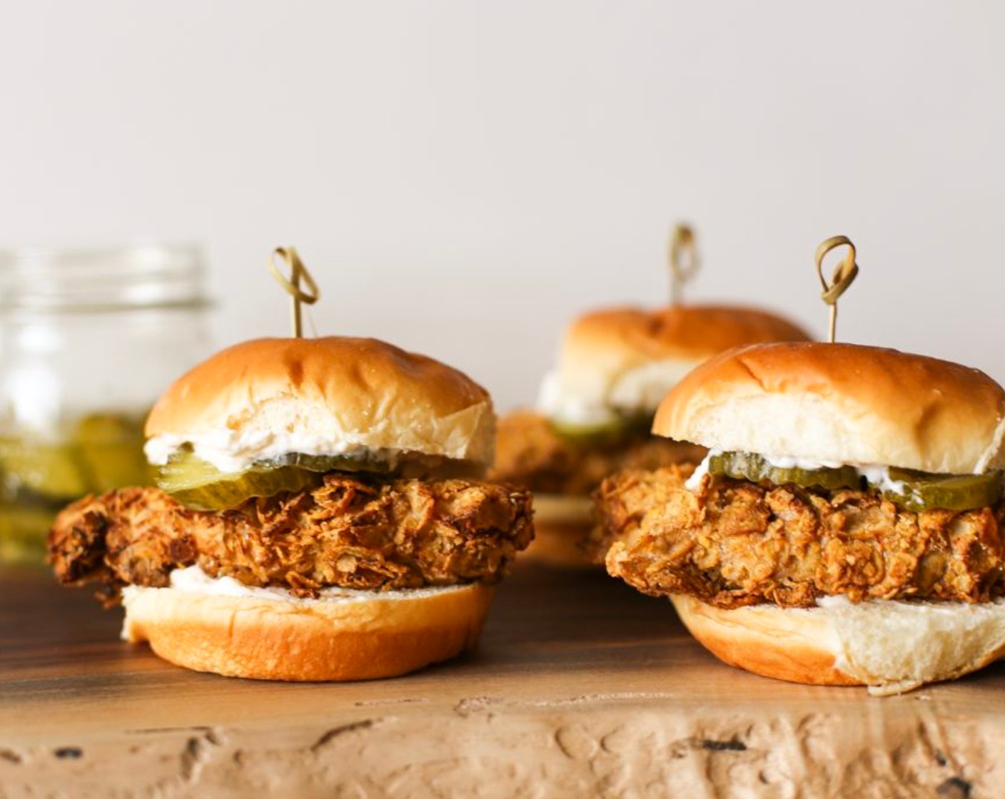 step 6 Butter (2 Tbsp) and toast your Soft Bread Rolls (8), spread each side with Mayonnaise (to taste), Hot Sauce (to taste), garnish with a Pickle Slices (to taste), and top with your fried chicken.