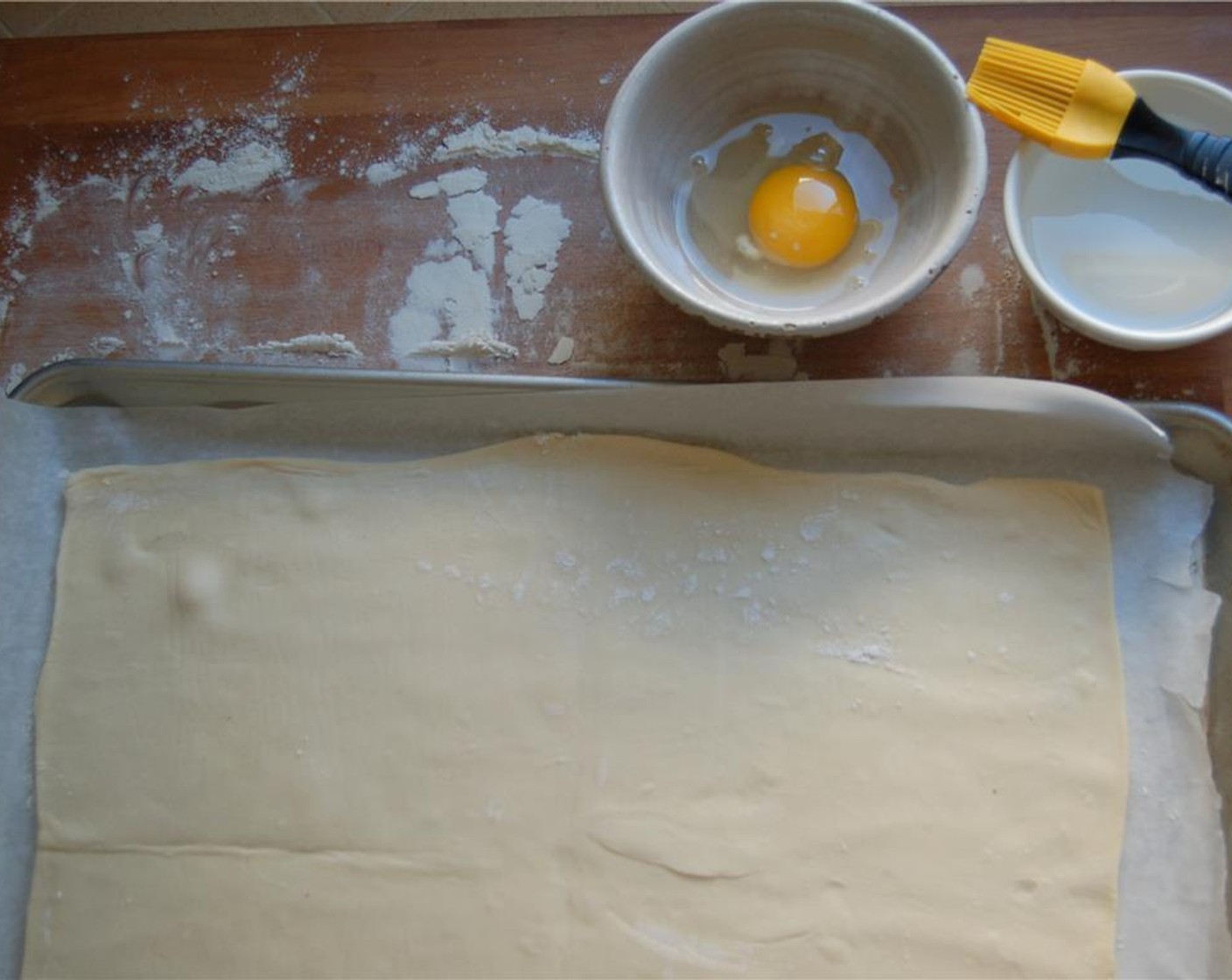 step 2 Roll out Puff Pastry (1)  on a lightly floured surface to a 10 x 11 rectangle. Transfer to a parchment lined baking sheet.