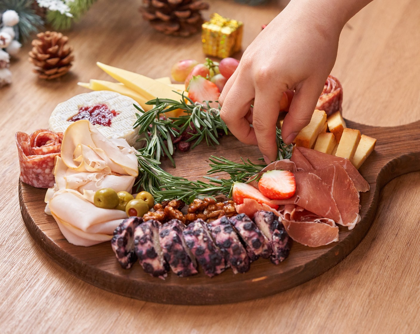 step 5 Fill the remaining spaces with Grapes (1 cup), Fresh Strawberry (1/2 cup), Candied Walnuts (1/2 cup), Dried Cranberries (1/2 cup), and Olives (1/2 cup). Decorate the inner circle with Fresh Rosemary (8 sprigs) and serve with Crackers (to taste).