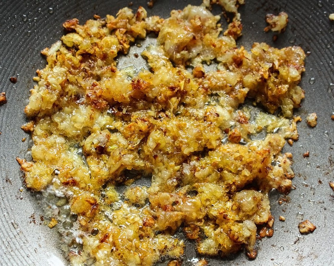 step 12 Add in the garlic/ginger/shallot mixture and brown it. Keep stirring, garlic burns quickly – especially near the edges of the pan.