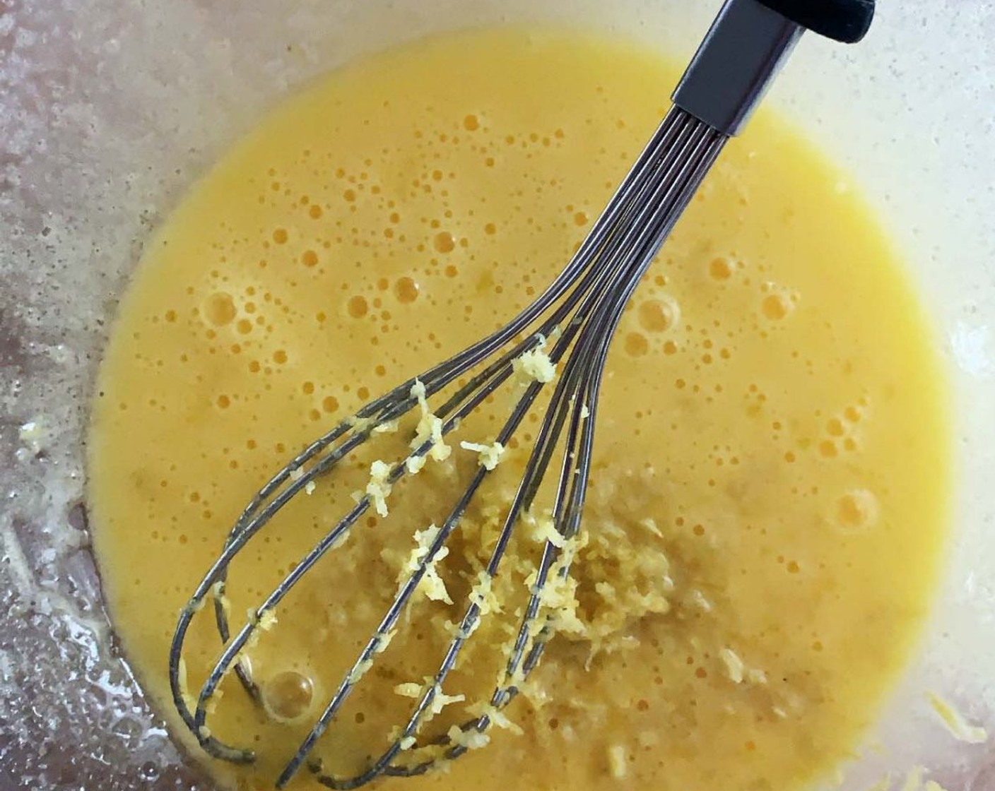 step 2 In a bowl whisk one whole Eggs (2) and one egg yolk, Granulated Erythritol (1/2 cup), and Light Extra-Virgin Olive Oil (3 oz). Add in the Lemon (1/2).