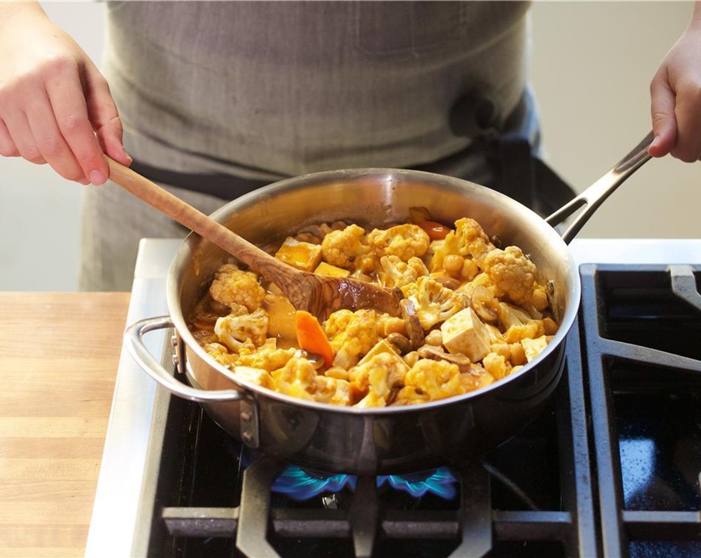 step 7 Season with Salt (1/2 tsp) and then add in the vegetable broth along with the chickpeas, onions, Cauliflower Florets (3 cups), carrots, mushrooms, and tofu. Gently stir to combine. Bring back to a boil, reduce heat to simmer, cover, and cook for fifteen minutes.