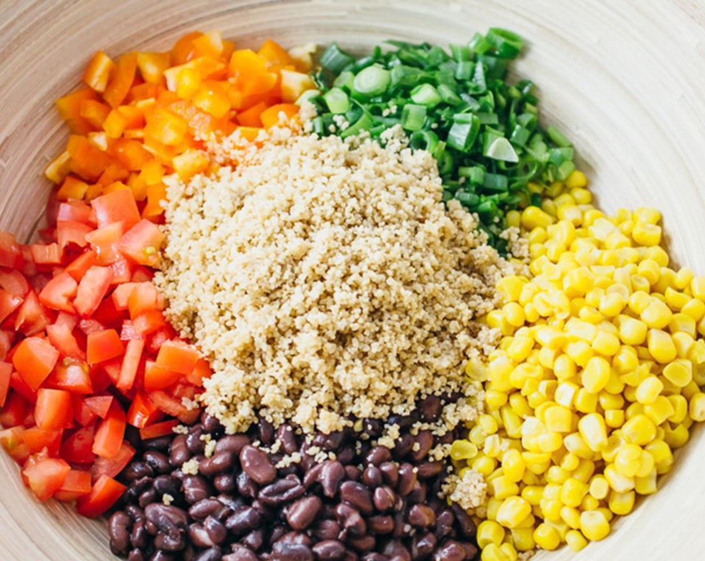 step 3 Combine the coucous, Black Beans (1 can), Corn (1 can), Roma Tomatoes (3), Orange Bell Pepper (1), Scallion (1 bunch), Cayenne Pepper (1/2 tsp), McCormick® Garlic Powder (1/2 tsp), {@10:}, Lemon (1), Olive Oil (1/4 cup) and Fresh Cilantro (1 bunch) in a large mixing bowl.