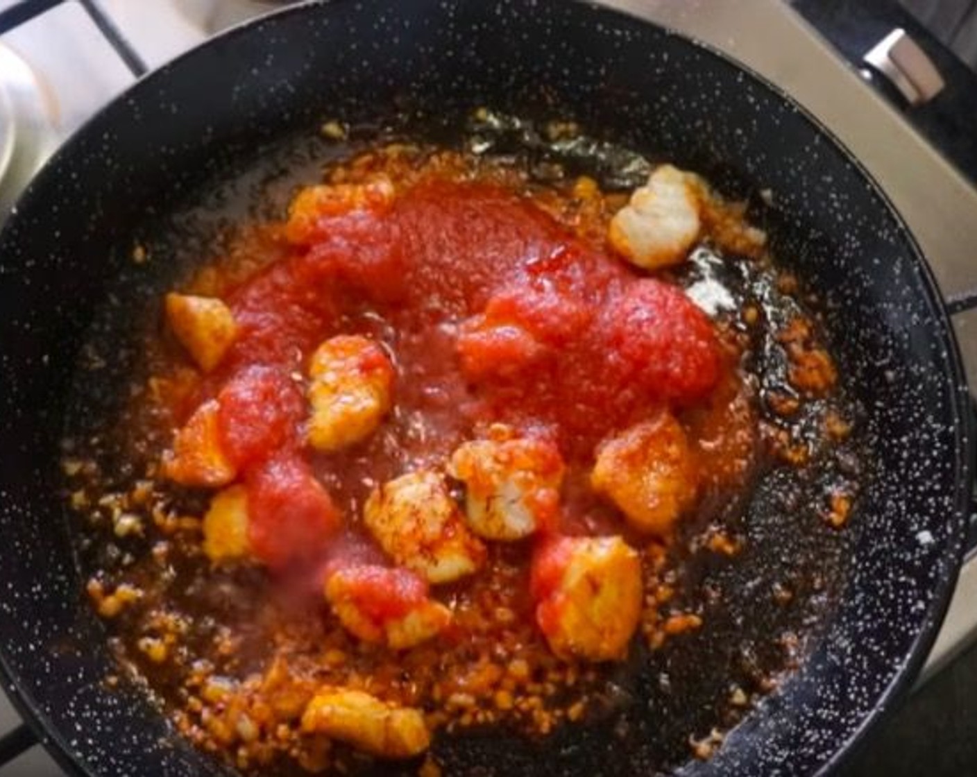 step 10 Make another well and add the Garlic. then 30 seconds later add Spanish Smoked Sweet Paprika (1/2 tsp) and Canned Tomato Purée (1/2 cup). Mix everything together, then season with additional sea salt.