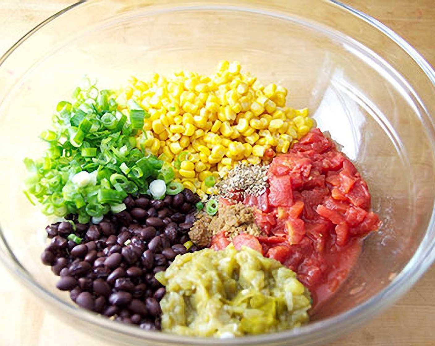 step 2 Combine Black Beans (1 can), Tomato (1 can), Frozen Corn Kernels (2 cups), Diced Green Chiles (1 can), Scallion (1 bunch), Chili Powder (1 tsp), Ground Cumin (1 tsp), Dried Oregano (1/2 tsp), and Salt (1/2 tsp).