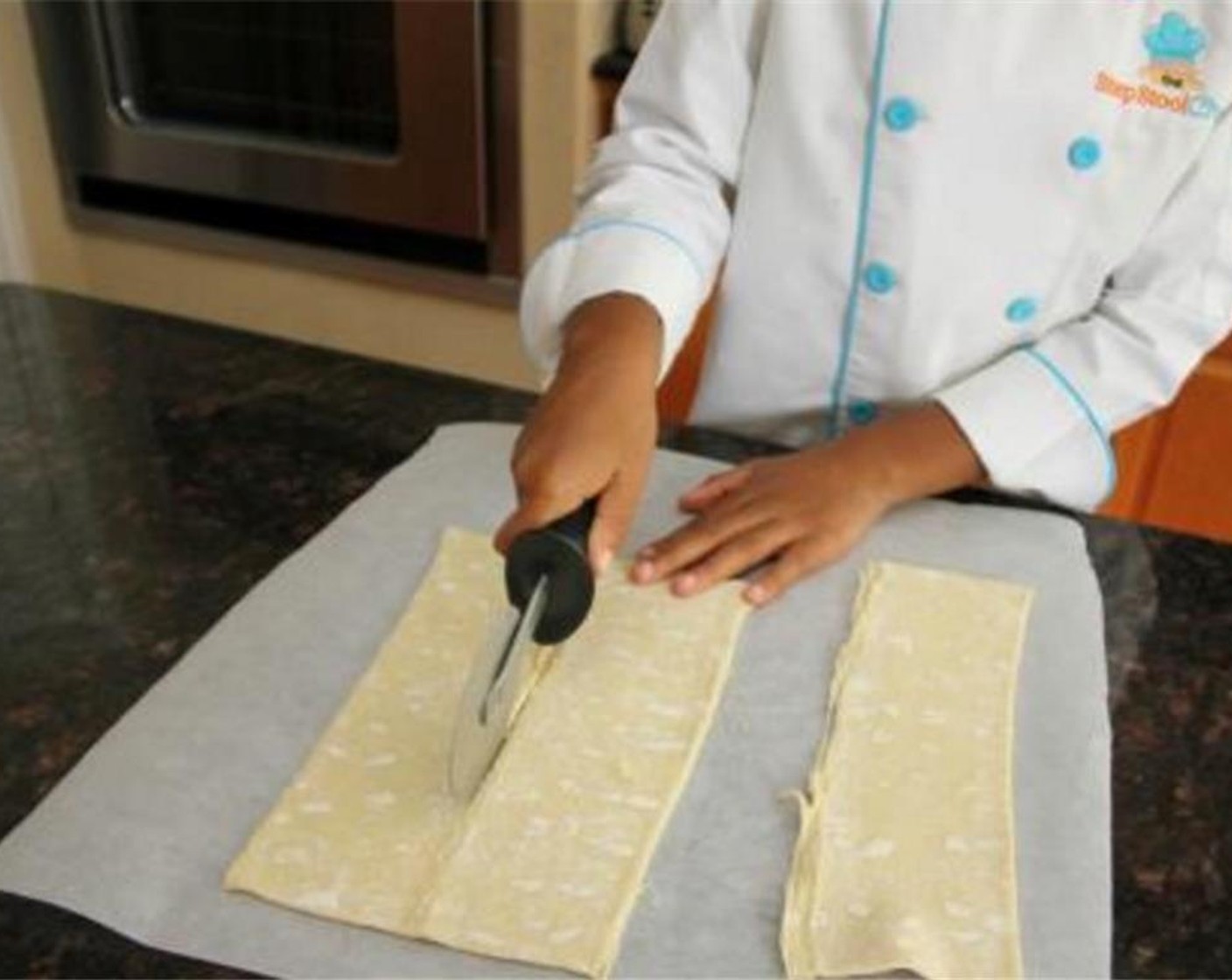 step 3 Cut along the puff pastry sheets fold lines to create three strips.