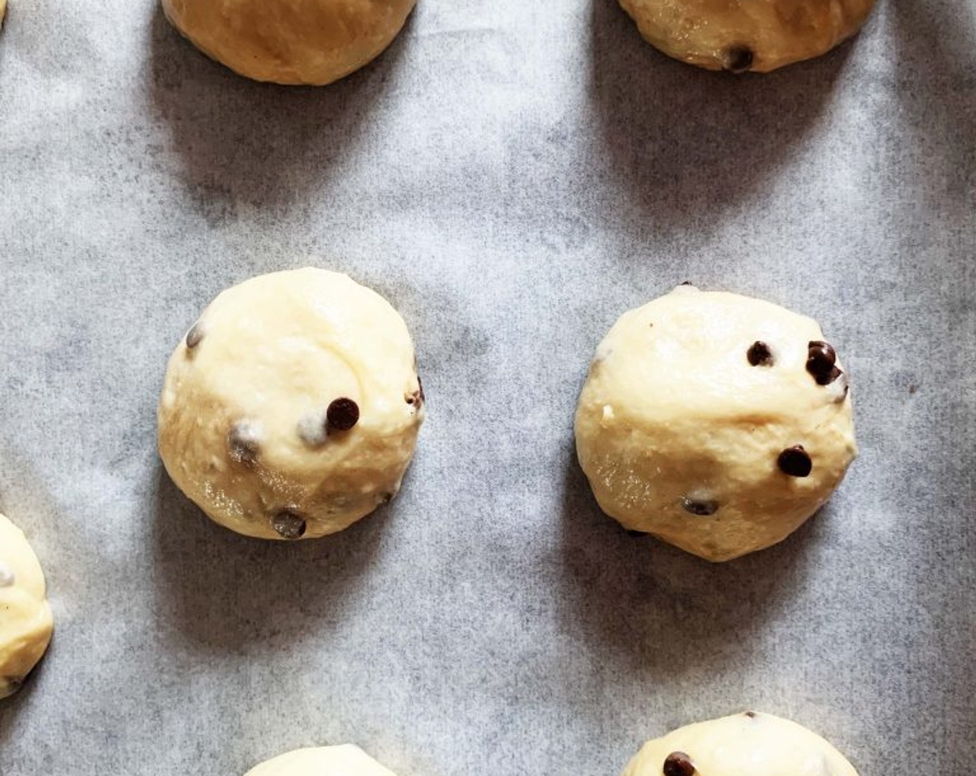 step 9 Cut off pieces of 50-60 grams each, round them into small balls, and lay them on your baking tray (layered with parchment paper). Let them rest for 1 hour.